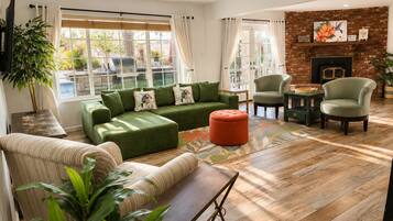 A modern living room with a sectional sofa, armchairs, a coffee table, and a fireplace.