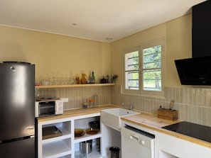 A kitchen with a refrigerator, microwave, sink, and dishwasher. - Vacation Home in the Alpilles, Provence (Noves)