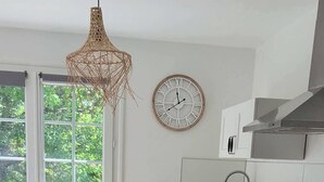 A kitchen with a modern design, featuring a built-in oven, a sink, and a hanging light fixture. - Meschers. Beach within walking distance, garden & terrace (Meschers-sur-Gironde)