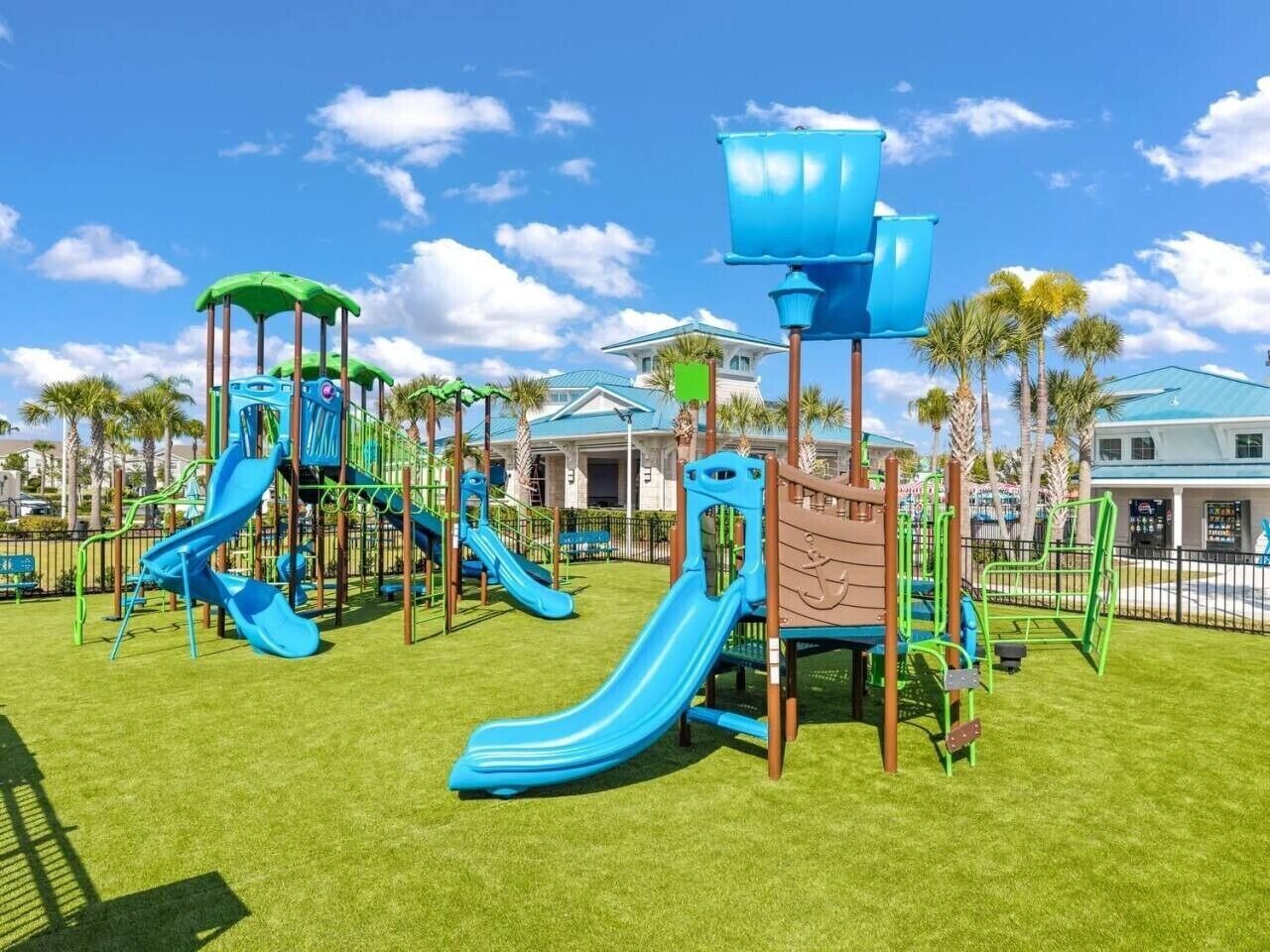 A playground with multiple slides and climbing structures.