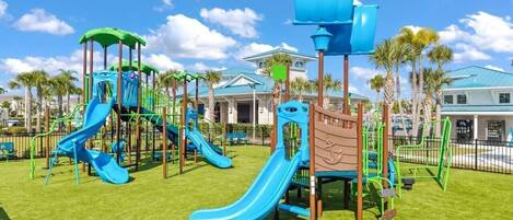 A playground with multiple slides and climbing structures.