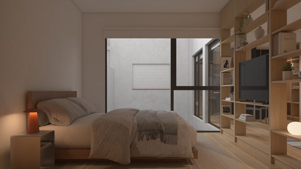 Un dormitorio moderno con cama, mesita de noche y estanterías empotradas con televisor.