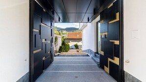 A corridor with a view of a mountain and a building in the distance. - Luxury Aparthotel MejtasHills - Old Town (Sarajevo)