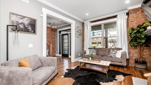 A modern living room with a grey sofa, a brown sofa, a coffee table, and a black and white rug. - Historic Home Near Downtown - Sleeps 14 - Arcade (Columbus)