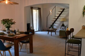 A dining area with a wooden table, chairs, and a vase of flowers. - A heavenly spot in gigaro, 5min from pl6 (La Croix-Valmer)