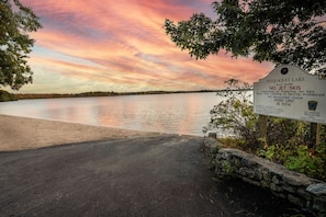 A sunset view at Wequaquet Lake with a sign prohibiting jet skis and a speed limit of 35 mph. - Lakewind House - sauna, hot tub, 5 min to Lake (Barnstable)