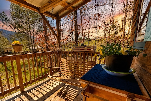 Covered front porch as the sun is setting on the farm.
