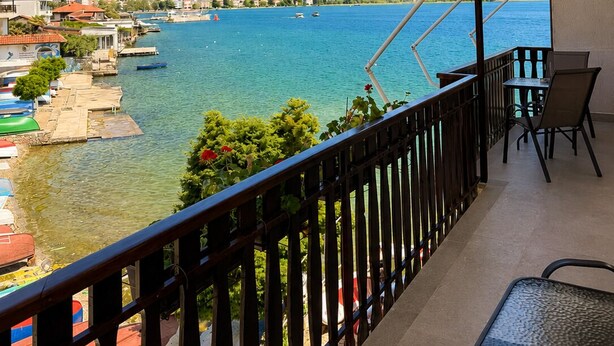 A balcony with a view of a lake, boats, and a distant town. - Villa Lucija - Old town and Lake view Apartment (Ohër)
