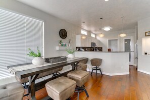 A modern kitchen with a central island, wooden flooring, and pendant lighting. - Heated Pool! Hot Tub! Volleyball court! 3-bedroom, 3-Bathroom Fabolous Home! (Albuquerque)