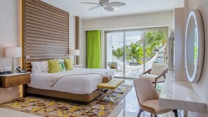 A modern hotel room with a bed, bedside table, lamp, chair, and a large window with a view of palm trees. - Luxury 2-bedroom Ocean view condo , Gym Spa & Infinity Pool (Cancún)