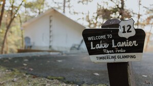A welcome sign for Lake Lanier Timberline Glamping.
