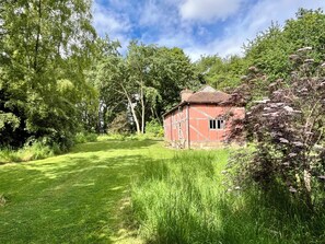 Property grounds - A unique Suffolk timber-framed cottage set within private lawns and woodland. (Chevington)