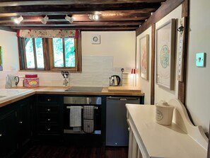 Private kitchen - A unique Suffolk timber-framed cottage set within private lawns and woodland. (Chevington)
