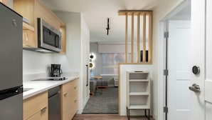 A compact kitchen with a refrigerator, microwave, and coffee maker. - Towneplace Suites By Marriott Colorado Springs I-25 South (Colorado Springs)