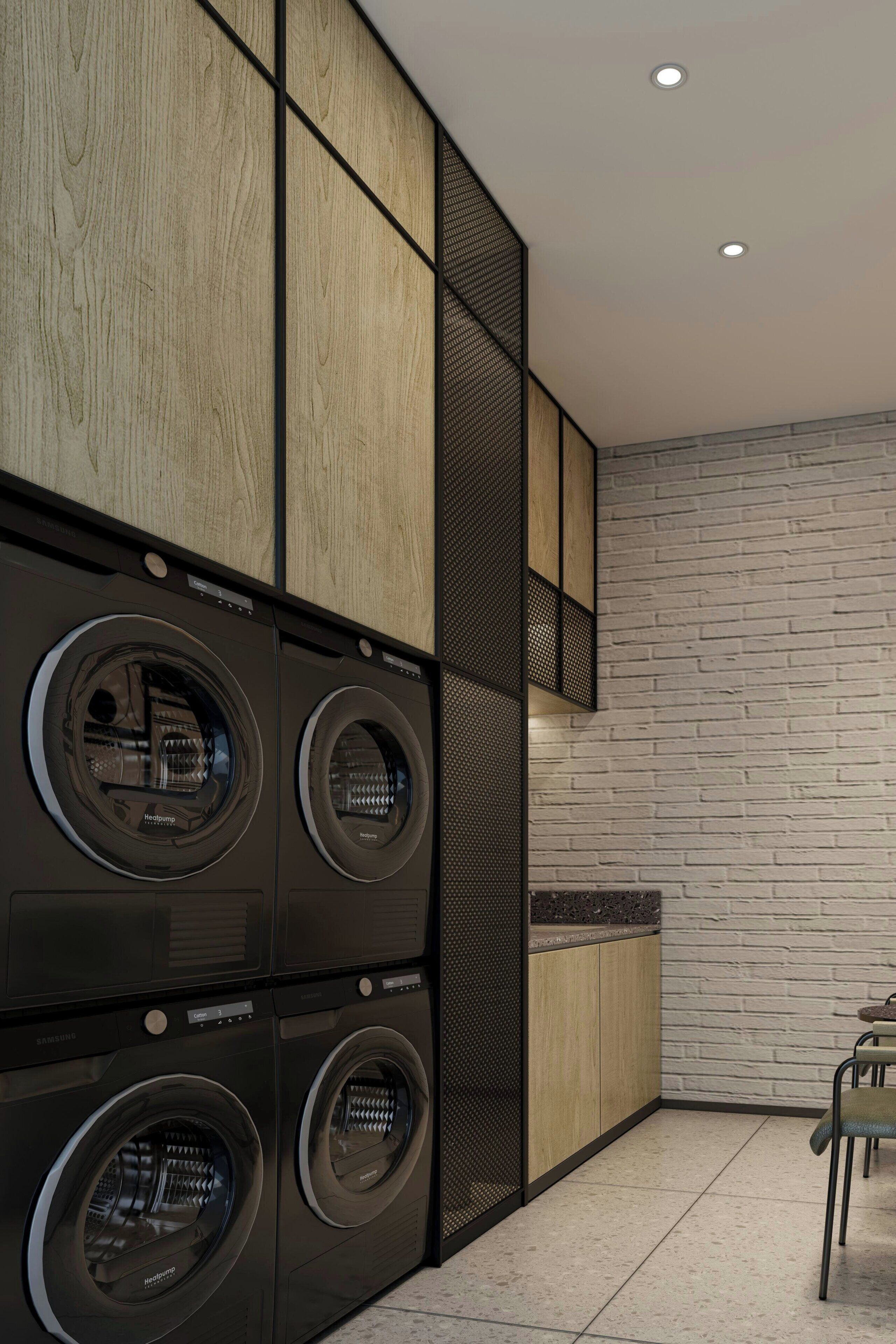 Une buanderie moderne avec des lave-linge et des sèche-linge superposés, un mur recouvert de panneaux en bois et un mur d’accent en briques.