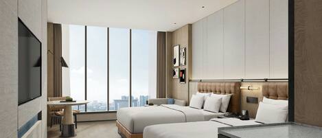 Una habitación de hotel moderna con dos camas, una zona de comedor, un televisor y vistas a la ciudad.