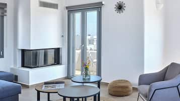 Una sala de estar moderna con chimenea, un ventanal y vista a la ciudad.
