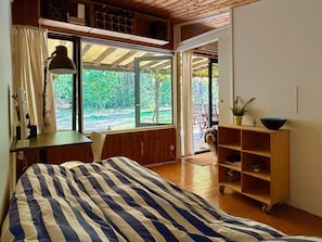 A room with a bed, a desk, a chair, a window, and a door leading outside. - 4 Star Holiday Home in Vaeggerlose (Vaeggerlose)