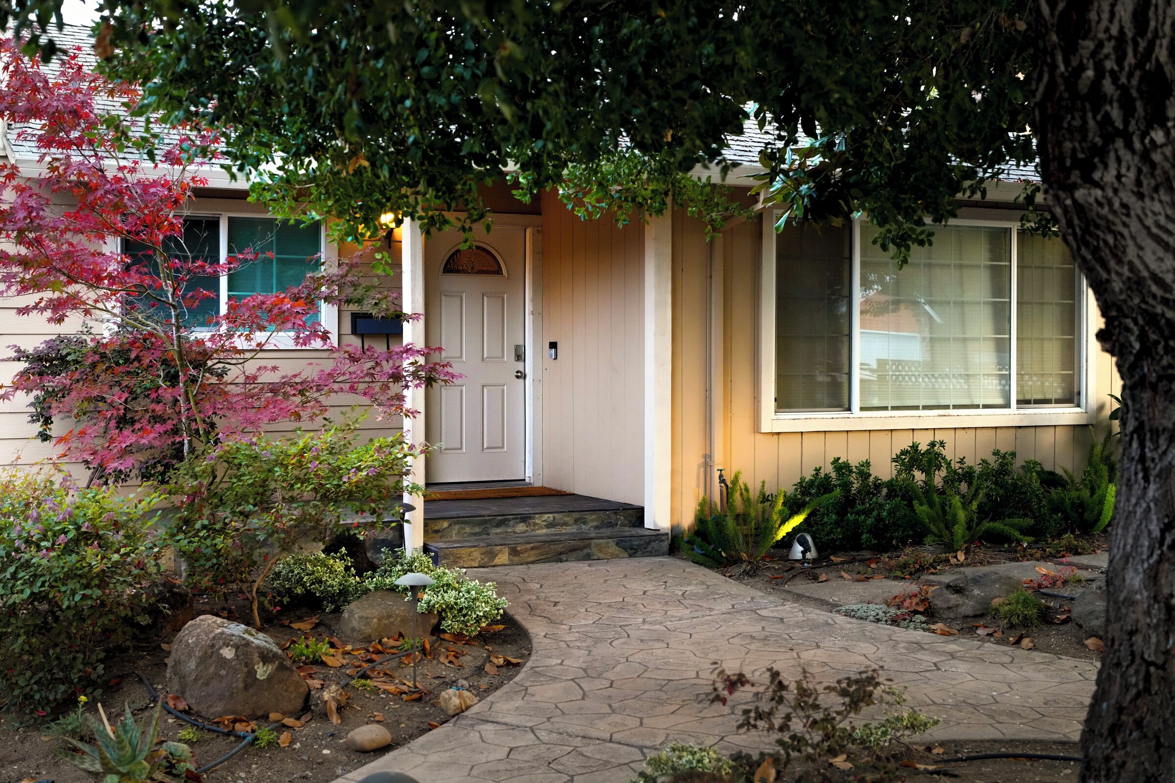 A house with a front porch, a door, and a window.