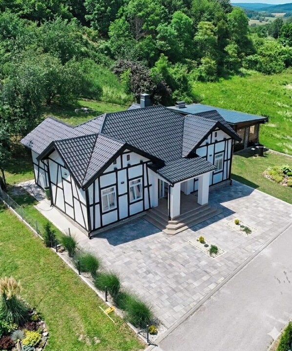 A large, modern house with a symmetrical design, featuring a central entrance, multiple windows, and a well-maintained lawn. - Adorable and premium 2-bedroom house with AC in welcoming Vrdnik (Vrdnik)
