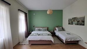 A room with two beds, a hanging light fixture, and a painting on the wall. - Adorable and premium 2-bedroom house with AC in welcoming Vrdnik (Vrdnik)