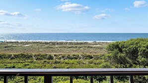 A coastal view with a beach, ocean, and vegetation. - Luxury Direct Oceanfront 3BR Panoramic Ocean Views (Hilton Head Island)