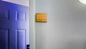 A door with a textured wall beside it. - Eastern Inn Peaked Mountain Escape (North Conway)