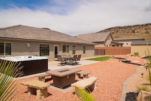 A residential area with a hot tub, outdoor seating, and a landscaped garden.