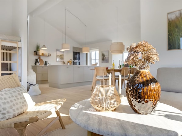A modern living room with a sofa, a coffee table, and a decorative vase. - "Raimund" - 600m from the sea by Interhome (Løkken)