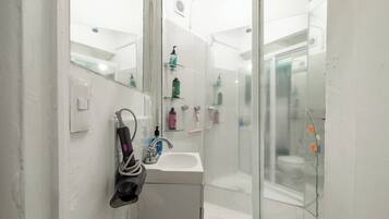 Shower, hair dryer, slippers, towels