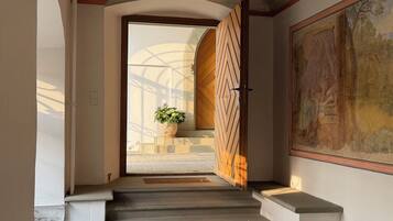 A staircase leading to a room with a large painting on the wall.