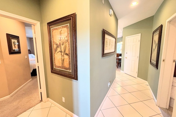 Entry hallway with tile flooring, neutral finishes, and easy access to the main living areas and bedrooms.