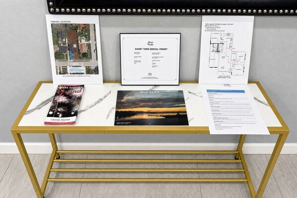 A display table with a rental permit, a map, a fire exit plan, and brochures.
