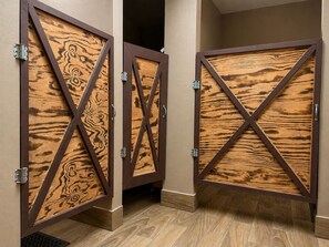 A hallway with two wooden doors featuring a cross design.