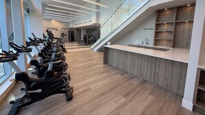 Ett gym med motionscyklar, styrketräningsmaskiner och en juicebar.