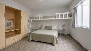 A bedroom with a bunk bed, a wardrobe, a desk, and a window. - Surf & Work Retreat - Private Pool - Fast WiFi (Punta Hermosa)