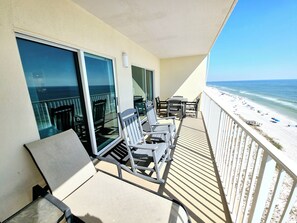 A balcony with a view of the beach, equipped with chairs and tables. - Newly Refreshed Gulf Front 2 King Condo, Sleeps 6 (Gulf Shores)