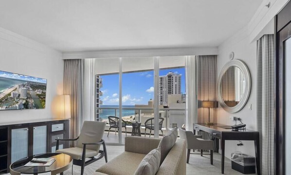 A hotel room with a balcony, a TV, a desk, and a sofa. - Fontainebleau 2Dbl Queen Beds City View (Miami Beach)
