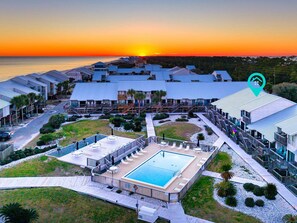 A resort with multiple buildings, a swimming pool, and a sunset view. - Ocean Mile K-10, Poolside views, Beach View, Beach Gear Credit with Booking (St. George Island)