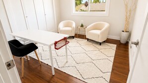A modern room with a white desk, two chairs, a rug, and a window with a view. - 4 BD, Pet Friendly - Modern chic beautiful, fenced yard (Vancouver)