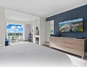 A modern hotel room with a large bed, a desk with a chair, a flat-screen TV, and a balcony with a view. - Tresor 2-1117 (Miami Beach)
