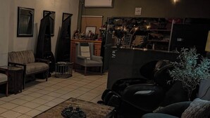 A living room with a coffee table, sofa, and a lamp.
