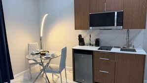 A compact kitchen with a microwave, coffee maker, and dishwasher. - Sanrai (Gros Islet)