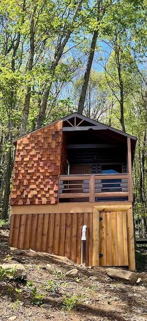 A wooden cabin with a sloped roof, a balcony with railings, and a door with a small window. - Shroom with a View - Cabin w King Bed Mtn Views (Black Mountain)