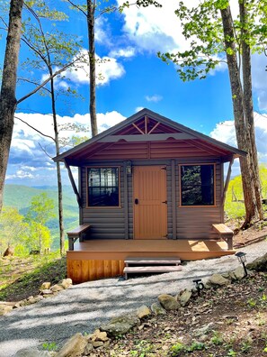 A cabin with a porch, a door, and windows. - Shroom with a View - Cabin w King Bed Mtn Views (Black Mountain)