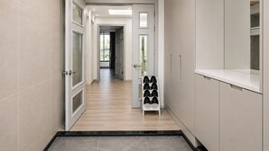 A hallway with a shoe rack, a door leading to another room, and a cabinet. - Seosansoo Golf & Resort (Seosan)