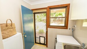 A compact bathroom with a sink, a toilet, and a shower. - Fourlees Breeze - Ocean Views - Sleeps 11 (Point Lookout)