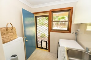 A compact bathroom with a sink, a toilet, and a shower. - Fourlees Breeze - Ocean Views - Sleeps 11 (Point Lookout)