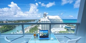 A balcony with a laptop, a bottle, and a glass of water. - Tresor 2-1709 (Miami Beach)