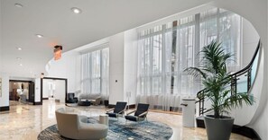 A spacious lobby with a marble floor, large windows, and modern seating. - Tresor 2-1709 (Miami Beach)